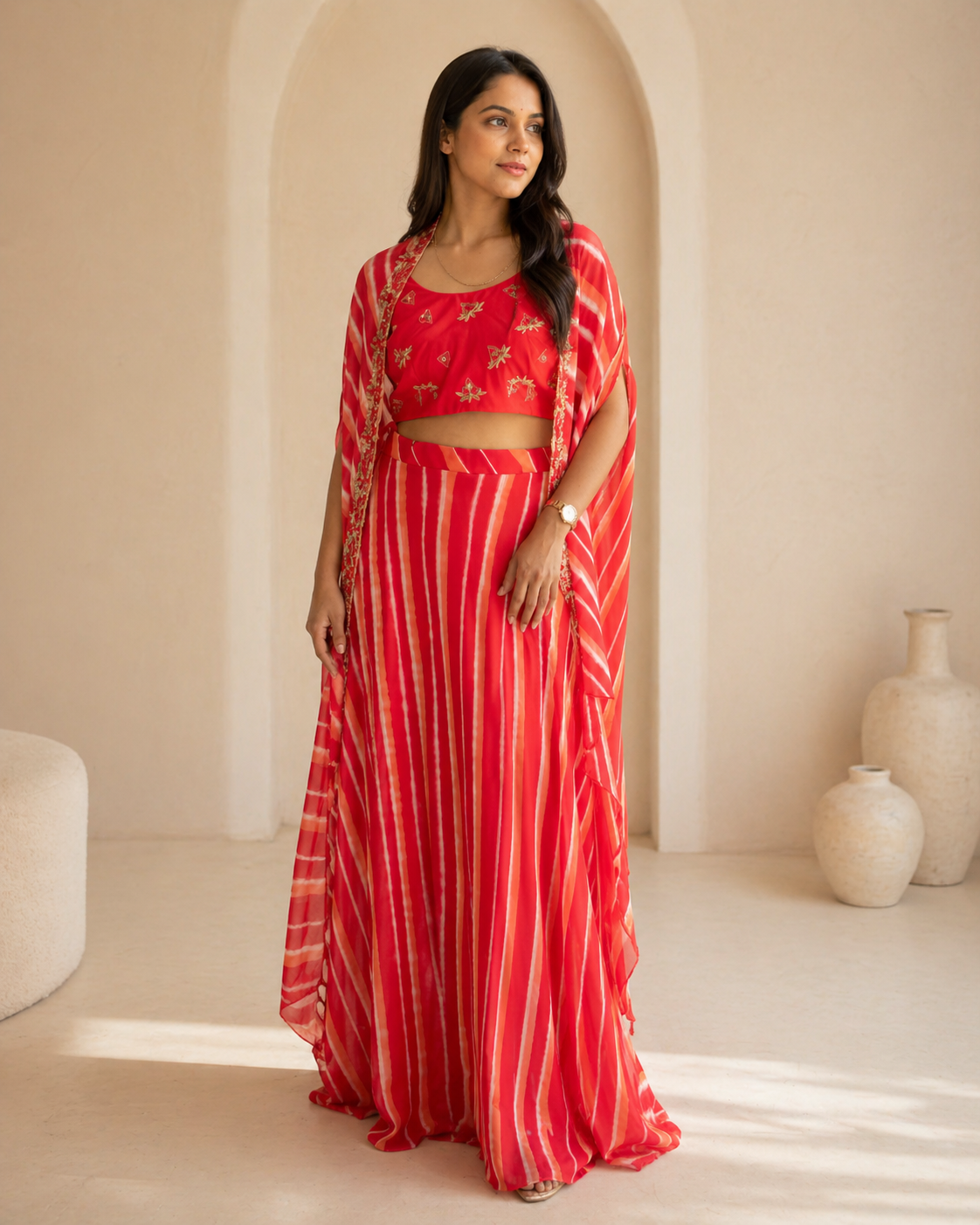 Red hand embroidered butti blouse and printed georgette lehanga and cape set