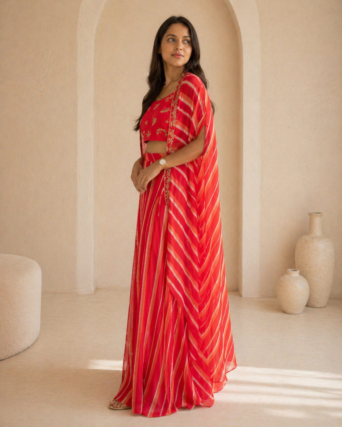 Red hand embroidered butti blouse and printed georgette lehanga and cape set